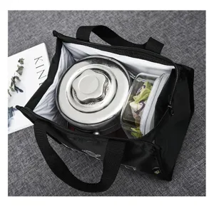 Detailed view of insulated lunch bag interior showing stainless steel box and food container.