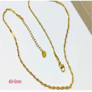 Close-up detail of the gold wave clavicle chain, featuring delicate snake chain design.