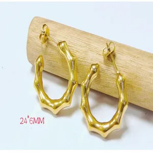 Detail shot of 18K gold plated stainless steel bamboo hoop earrings showing intricate texture.