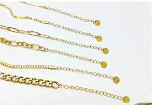 Detail shot of 5 gold stainless steel chain necklaces with extension tails. Fashion jewelry close up.