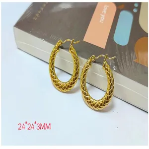 Gold textured woven hoop earrings detail shot, showcasing intricate metallic pattern and shine.