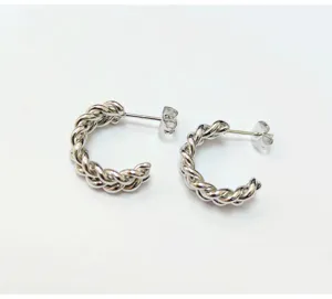 Silver twisted hoop earrings detailed view, stylish braided design stainless steel jewelry.