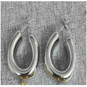 Chunky silver U-shaped hoop earrings, trendy minimalist statement metal jewelry for women.