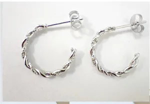 Detail view of twisted stainless steel hoop earrings, elegant minimalist daily item.