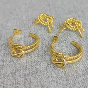 Gold stainless steel knot twist hoop earrings and stud set, stylish fashion jewelry accessory.