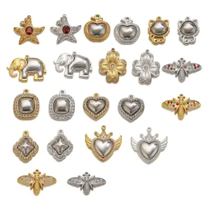 Detail shot of titanium steel rhinestone inlaid charms, assorted gold and silver DIY pendants.