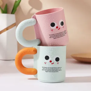 Cute plastic toothbrush cup with cartoon face and colorful handle for couple home bathroom use.