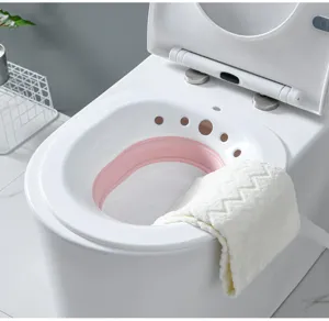 Foldable sitz bath basin detail view for postpartum care and hygiene, white and pink plastic.