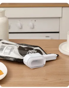 Plastic food bag sealing clip with pouring spout, convenient kitchen storage gadget for snacks.