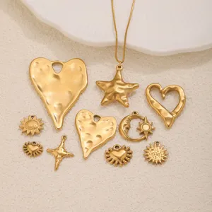 Detailed view of vintage textured titanium steel heart star moon DIY jewelry charms and pendants.
