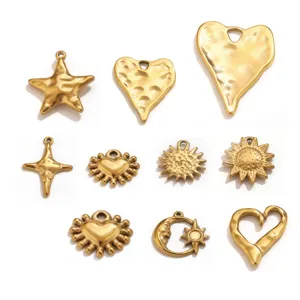 Close up of retro textured gold plated steel pendants, star and heart charms for DIY jewelry.