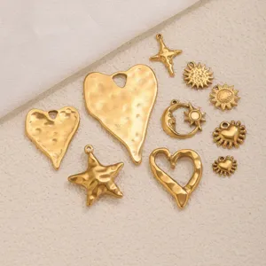 Closeup of retro gold textured metal charms, DIY pendant accessories set for handmade jewelry.