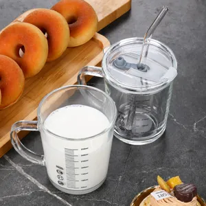 Clear glass water cup with scale markings, straw, and lid, perfect for daily drink use.