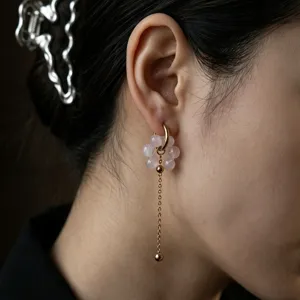 Elegant pink beaded flower drop earrings featuring a gold-toned hoop and delicate chain design.