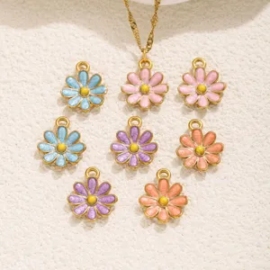 Primer plano de dijes de margaritas de esmalte colorido y detalles de collar de joyería.