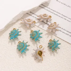 Detailed close-up view of blue and white enamel conch shell charms for DIY jewelry accessories.