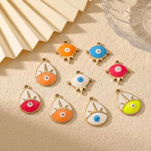 Close-up of colorful evil eye enamel pendants for DIY handmade jewelry and necklace making.