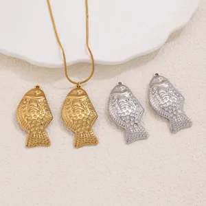 Stainless steel small fish pendants and necklace detail view showing embossed koi design finish.