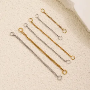 Close up view of stainless steel extension chains in gold and silver, detailed jewelry parts.