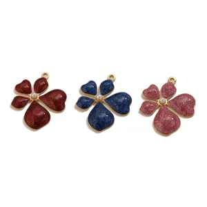 Detailed shot of glitter heart flower pendants, DIY metal jewelry making charms accessories.