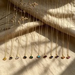 Detailed view of dainty gold chain necklaces featuring vibrant multi-color marquise gemstone pendants.