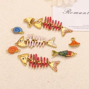 Detailed look at stainless steel enamel fish bone and shell charms for DIY crafts and jewelry.
