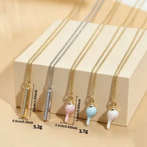 Detail view of macaron drip oil conch and diamond-paved bar pendant necklaces, elegant daily wear.