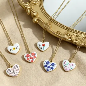 Detail view of trendy heart pendant necklaces with lovely printed patterns and gold chains.