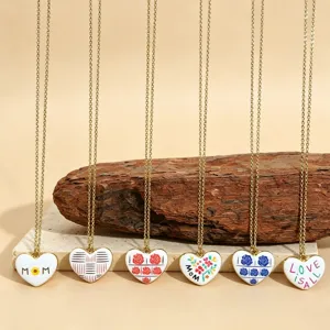 Close-up detail of stylish heart pendant necklaces featuring cute floral and letter designs.