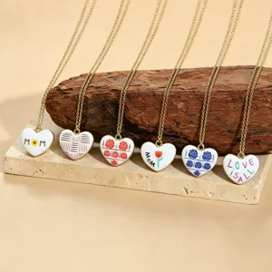 Gold chain necklaces with colorful enamel heart pendants featuring mom and love designs.