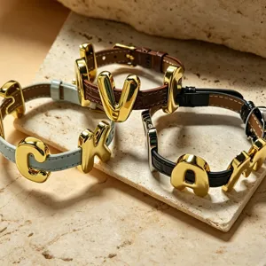 Vintage DIY leather strap bracelet with chunky metal letters, stylish retro accessory.
