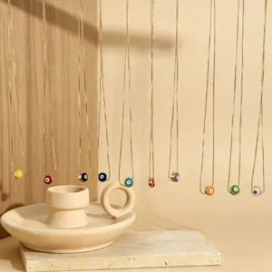 Delicate boze oog hanger ketting set met gouden kettingen en kleurrijke emaillen details.