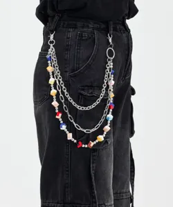 Detailed view of a multi-layer pants chain featuring metallic links and colorful cube charms.