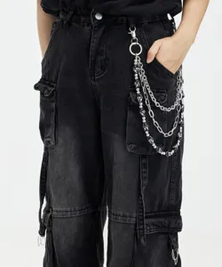 Close-up detail of multi-layer skull chain paired with black cargo jeans, hip-hop style.