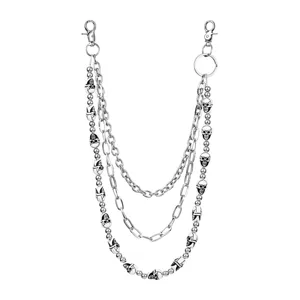 Detail view of three-layer hip-hop skull pants chain featuring metal links and bead charms.