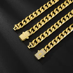 Gold Cuban link chain detailed view featuring polished alloy and rhinestone clasp design.