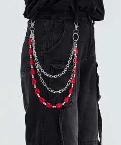Close-up of a multi-layer hip-hop pants chain with metal links and red money bag charms.