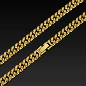 Close-up detail of the gold Cuban link chain necklace, showcasing shiny metal texture and clasp.