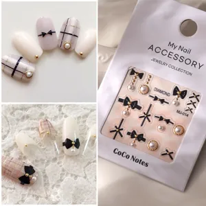 Black bow nail art stickers pearls and gold studs set for elegant manicures DIY nail decor.