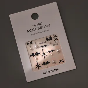 Elegant bow nail art charms with pearls and rhinestones, stylish metallic manicure decors.