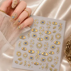 Retro gold foil nail art stickers featuring 3D evil eye, sun, and star designs for stylish manicures.
