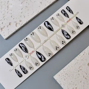 Close up detail of black and white ghost press on nails set on white display card.