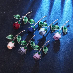 Elegant fabric rose flower brooch with metal stem and leaves, perfect for evening wear.