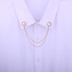 Detail shot of delicate gold-toned pearl collar pin with double tassel chains for shirts.