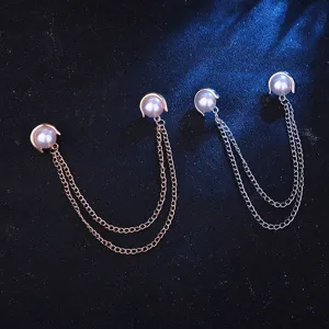 Close-up detail of double chain pearl collar brooch pin, elegant shirt collar accessory.