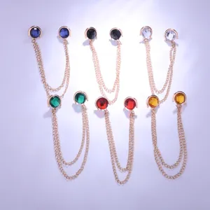Close-up detail of stylish metal collar chain with colorful crystal gemstones for shirt pins.