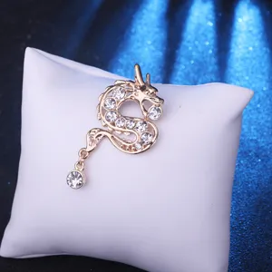 Close-up detail of the vintage gold dragon brooch featuring sparkling crystal rhinestones.