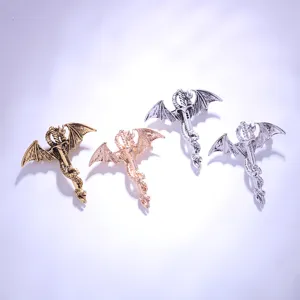 Close-up details of retro dragon sword brooches showcasing metallic finishes and wing carvings.