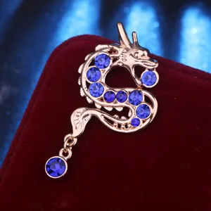 Detailed close-up of a retro Chinese zodiac dragon brooch with sparkling blue rhinestones for men.