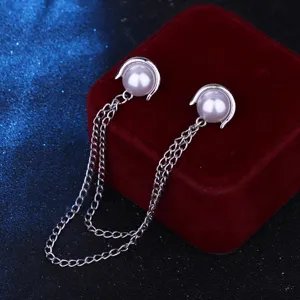 Close-up detail of double pearl collar pins with multi-layer tassel chains for elegant suit shirts.